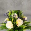 Flower Arrangement Contains Cream Roses Blue accent flowers & tall spiky grasses