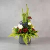 Flower Arrangement Contains Red Roses, Blue accent flowers, Red cherries & tall spiky grasses