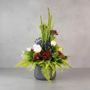 Flower Arrangement Contains Red Roses, Blue accent flowers, Red cherries & tall spiky grasses